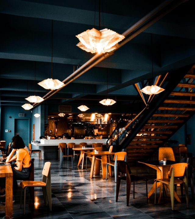 Elegant modern café with warm lighting and contemporary decor, creating a cozy atmosphere.